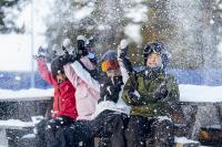 Child with a parent in a ski slope.