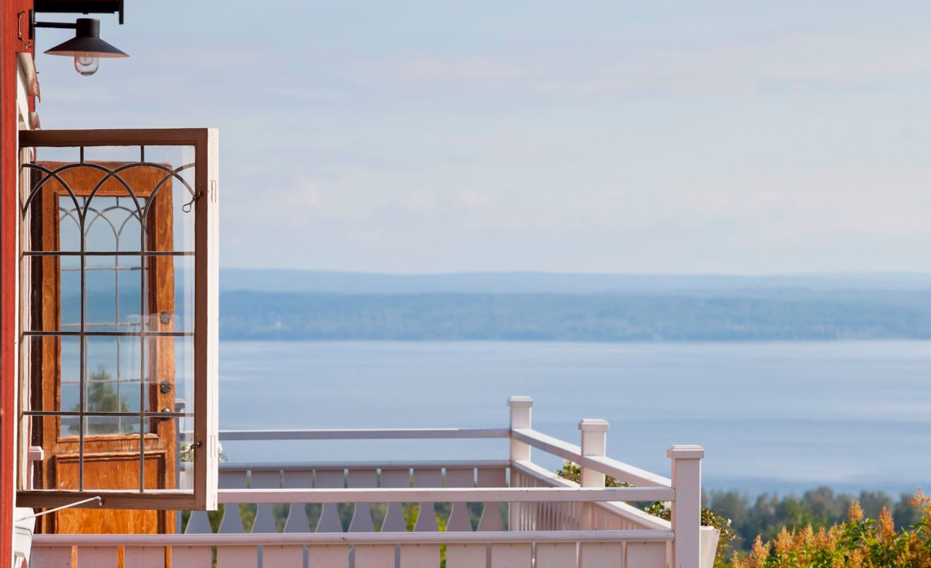 Vacker utsikt från en balkong över en sjö.