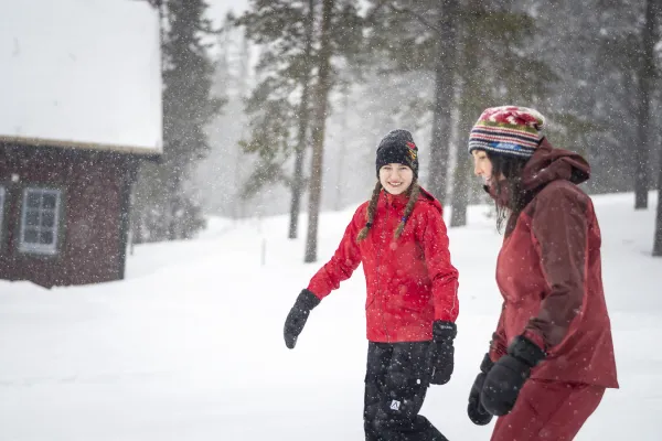 Barn och vuxen vandrar i snö.