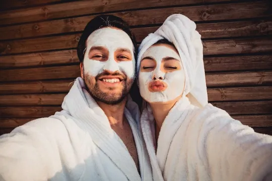 Couple with white bathrobes and face mask.