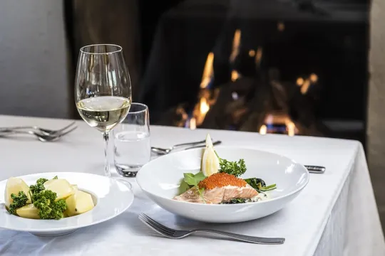 Dinner on the table with a fire in the background.