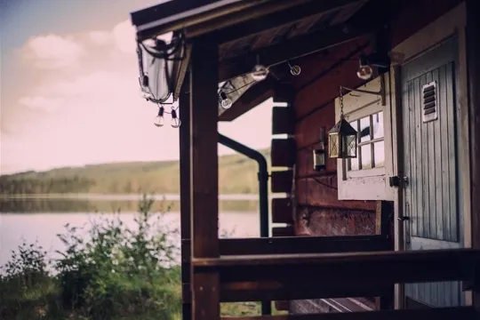 View of the lake from the veranda at the red-painted cottage.