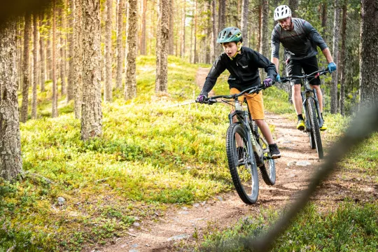 A boy and a man biking.