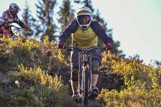 Downhill by bike descend paths on steep mountains.