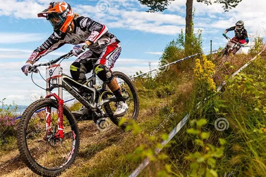  Downhill cyclist in full speed down the mountain.
