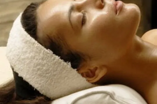 Face of a woman lying down with closed eyes.