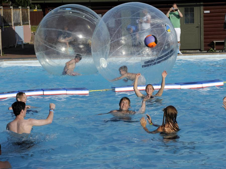 Kids in a pool playing with funballz