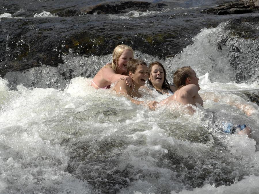 People are bathing in a waterfall