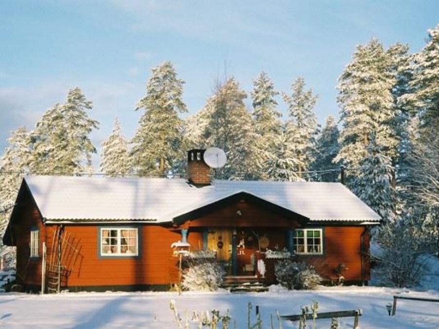 Red log cabin on a winter day.