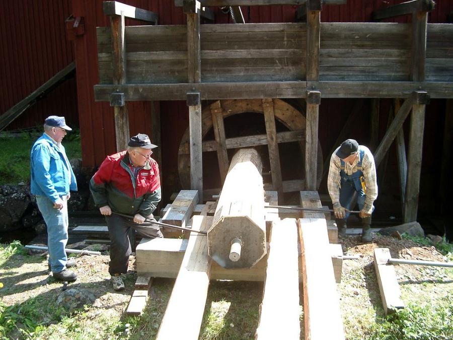 Men working with saw.