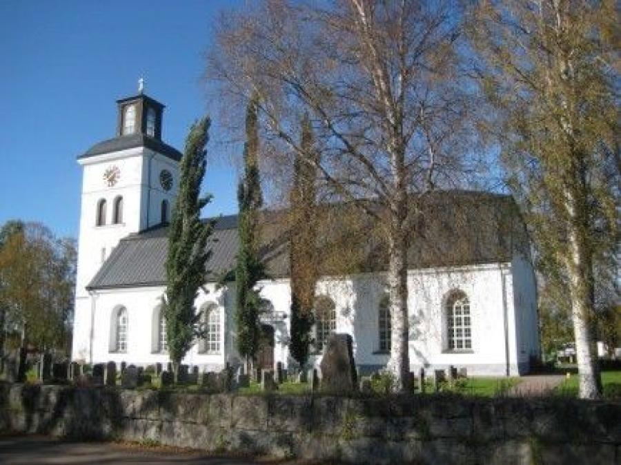 White church with towers and high windows.