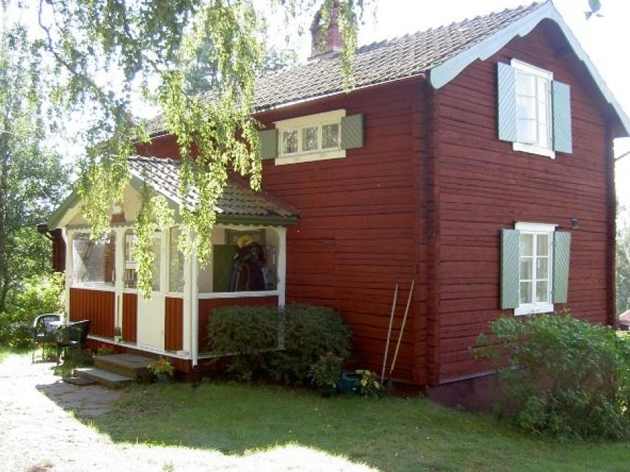 Red painted timber cottage.