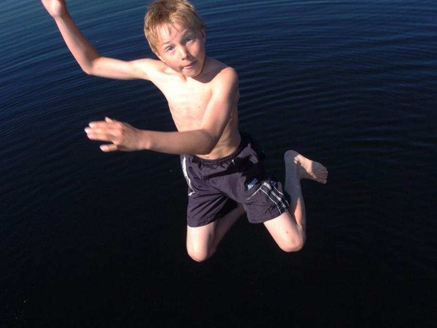 A boy is on his way to jump into the water