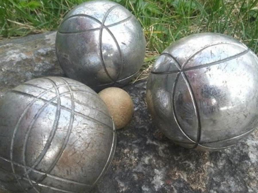 Three petanque balls , a smaller ball in the middle.