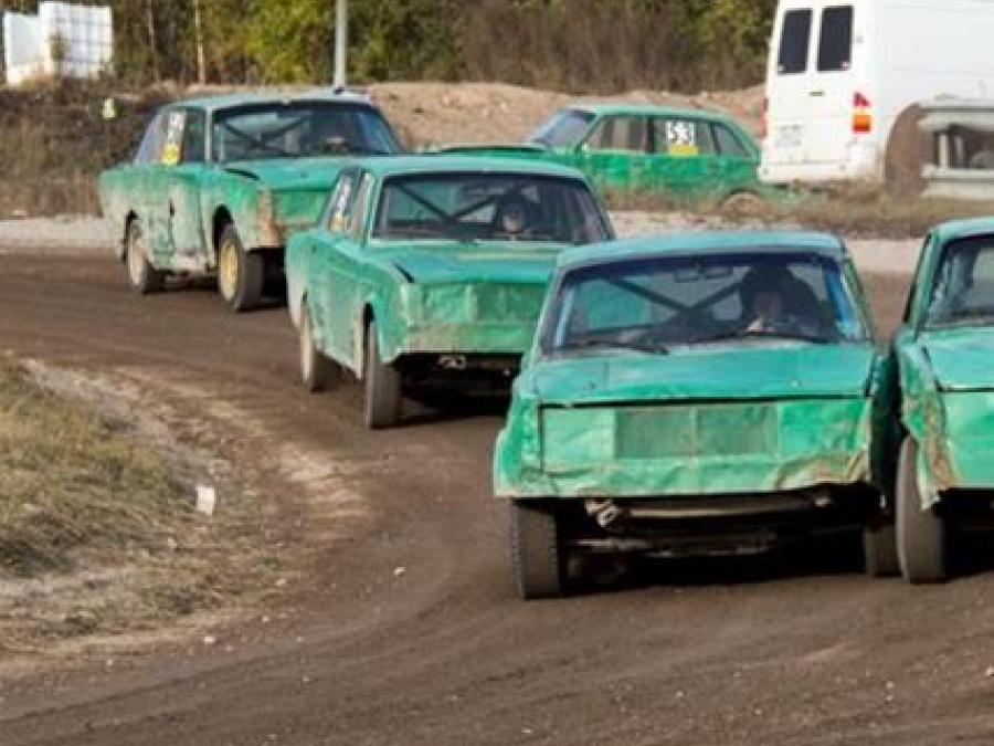 several cars on a rally track.
