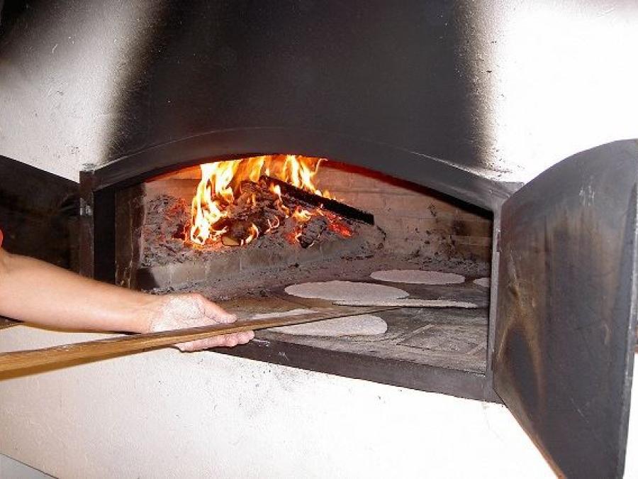 Baking oven with fire and breadbaking.