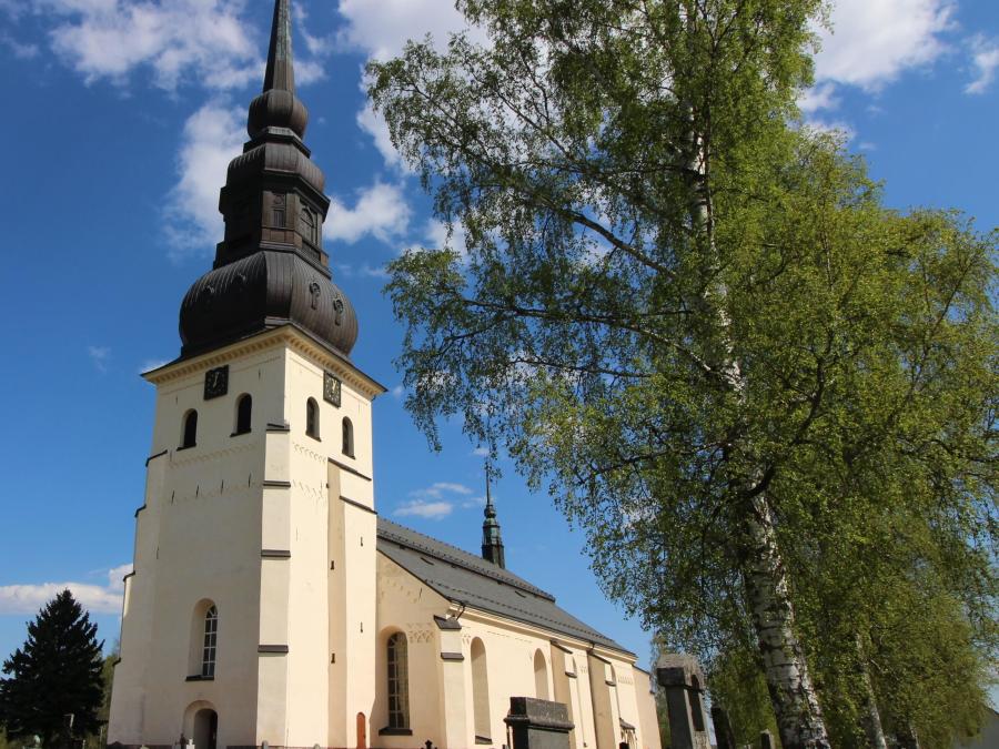 Stora Tuna Church, white with high steeple.