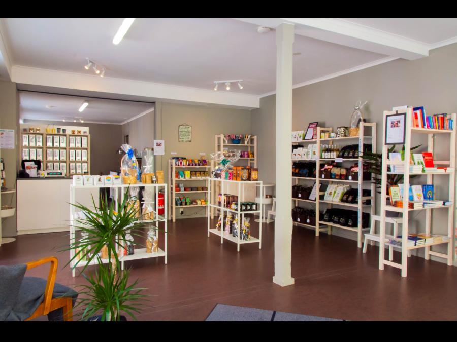 Interior image from the shop, white shelves with different products.