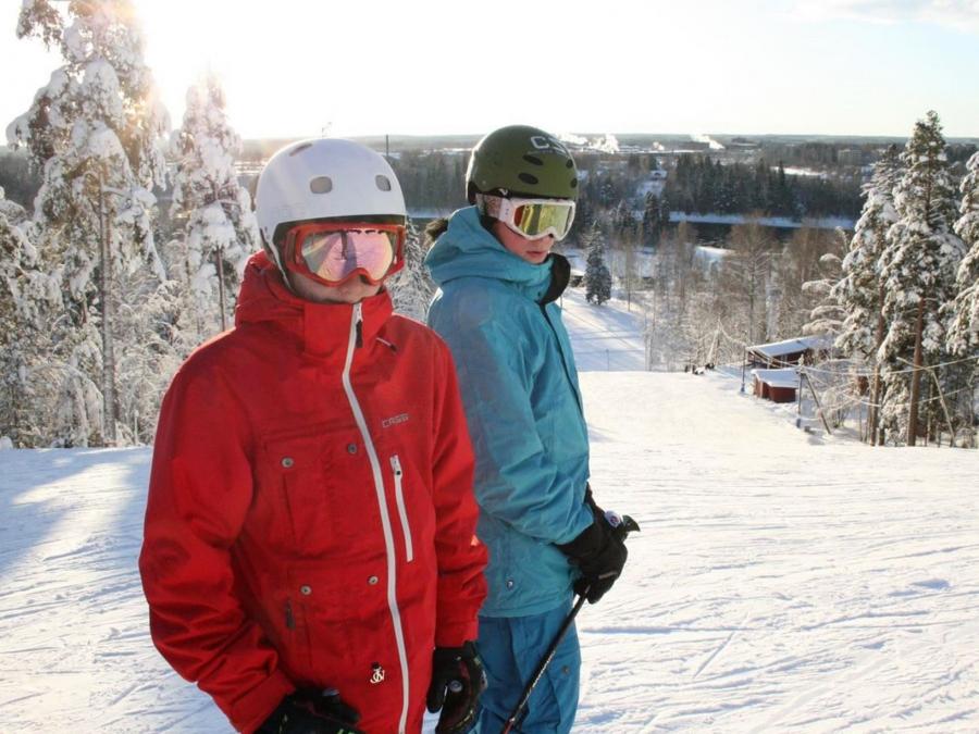 two people in the ski slopes.