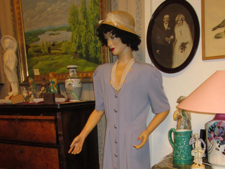 Mannequin with dress and hat.