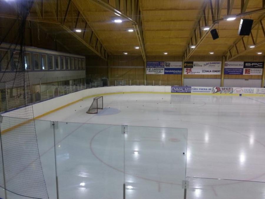 Indoor hockey rink with a goal cage.