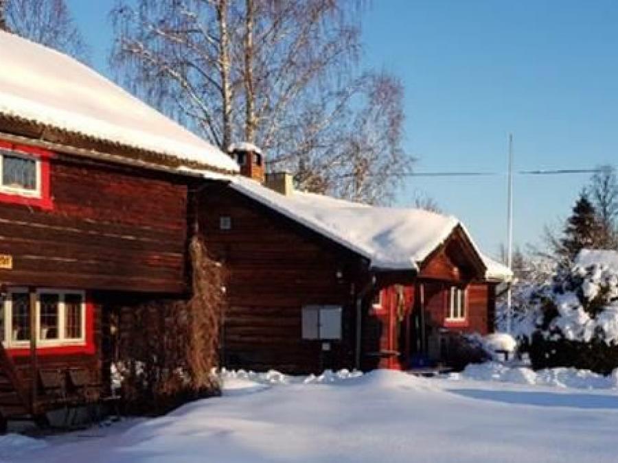 Timber buildings covered in snow.