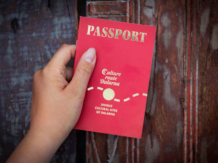 A hand holding a culture passport.