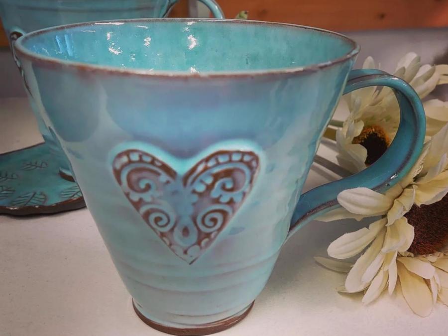 A turquoise mug with a heart.