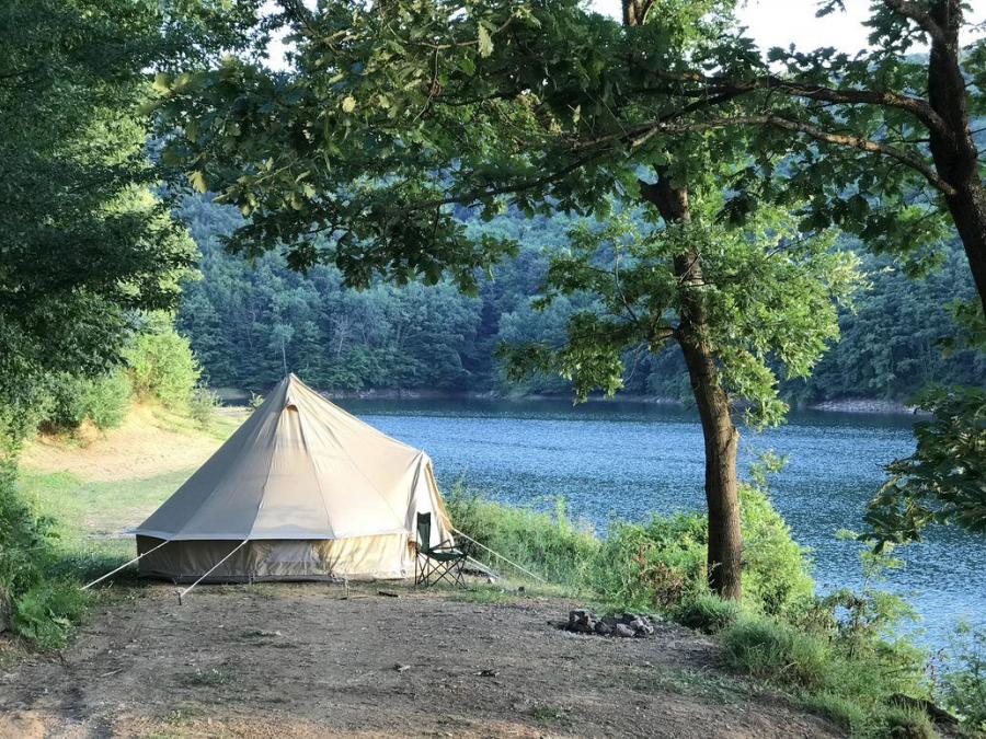 Glamping tent are set up by the river.
