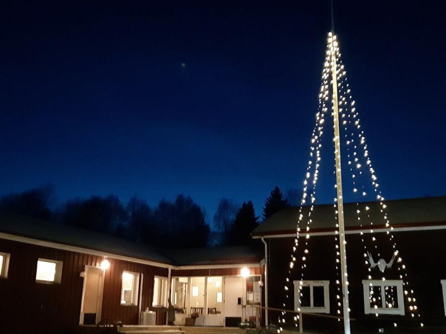 Hornberga Gård by night with lightning in the flagpole. 