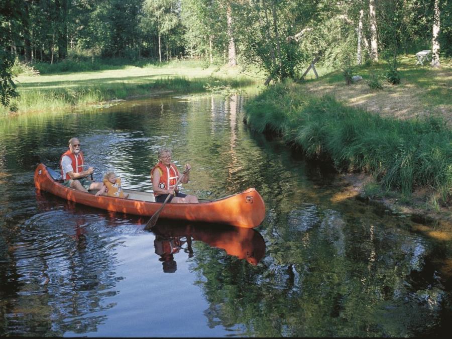 Adults and children in a canoe.