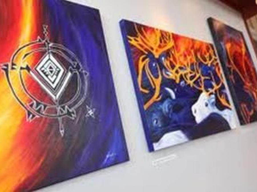 Sami art, paintings with Sami symbols and reindeer.
