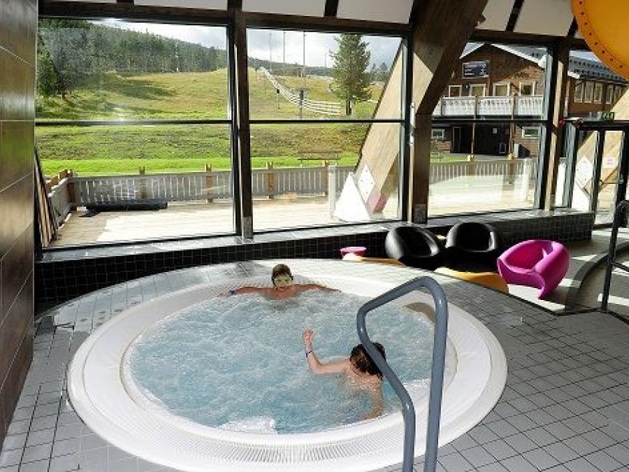 Small indoor pool with two children in.