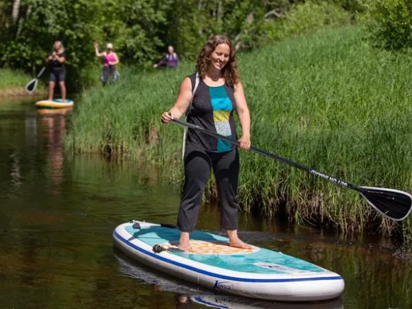 Women paddling on a river.