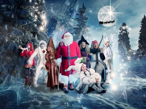 Santa and Fairytale characters in the forest in the winter night.