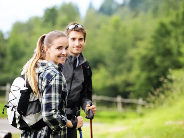 Young couple with backpacker and poles
