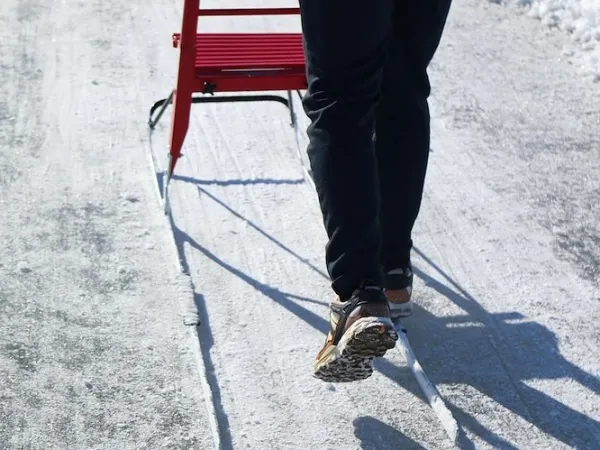 A person riding a kick-sled.