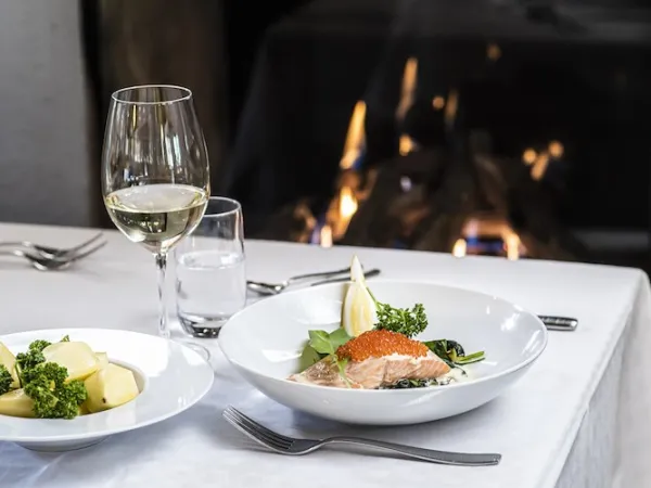 Dinner on the table with a fire in the background.