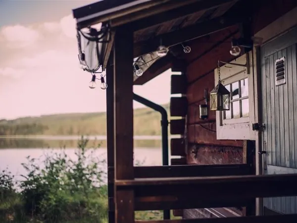 View of the lake from the veranda at the red-painted cottage.