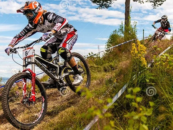  Downhill cyclist in full speed down the mountain.