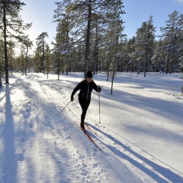 A woman doing cross country skiing.