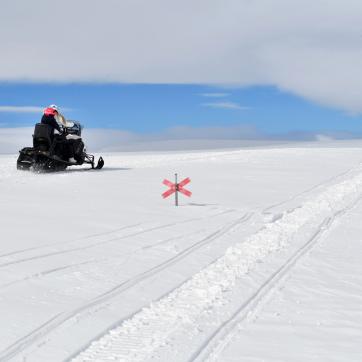 Snowmobile riders riding on a snowmobile trail in Idre.
