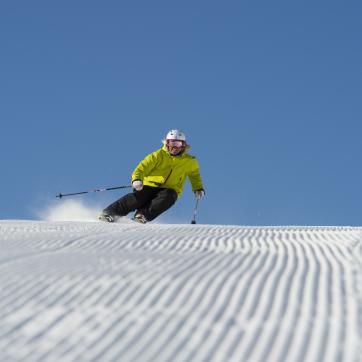 A girl at the top of the ski slope.