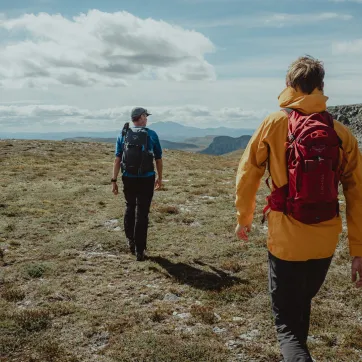A couple hiking in mountain enviroment.