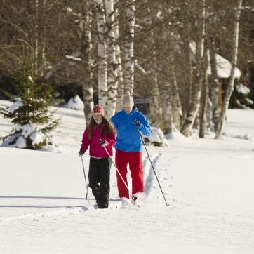 A couple doing cross country skiing.