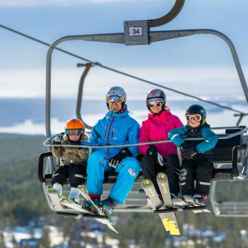 A family on a ski lift.