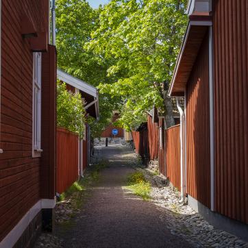 A narrow alley among red wooden houses in Falun.