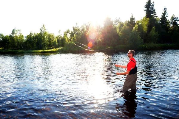 A man fishing in a river.