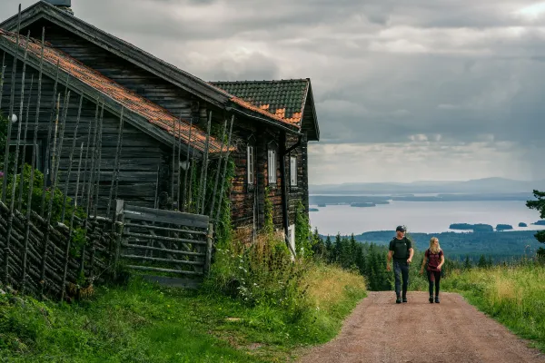 A couple hiking on a gravel road.