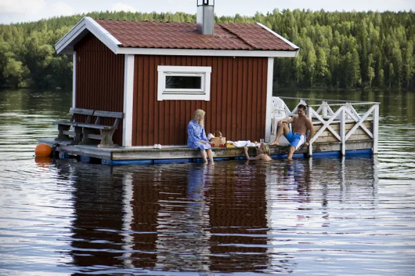 A floating sauna house on a lake.